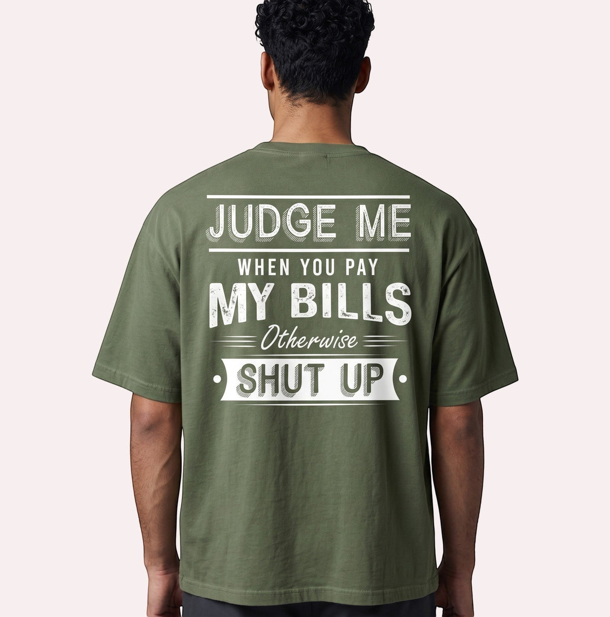 TrendyShift.Com olive green oversized cotton graphic tee with distressed white back print text on a male model